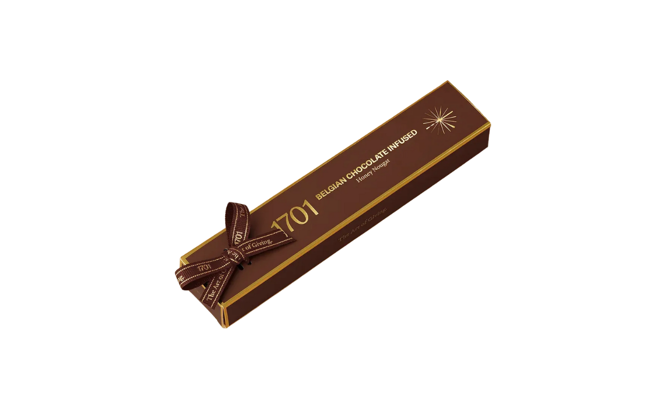 1701 Belgian Chocolate Infused Honey Nougat Bar 100g, hand‑wrapped with ribbon, showing smooth Belgian chocolate nougat texture in a premium South African artisanal presentation.