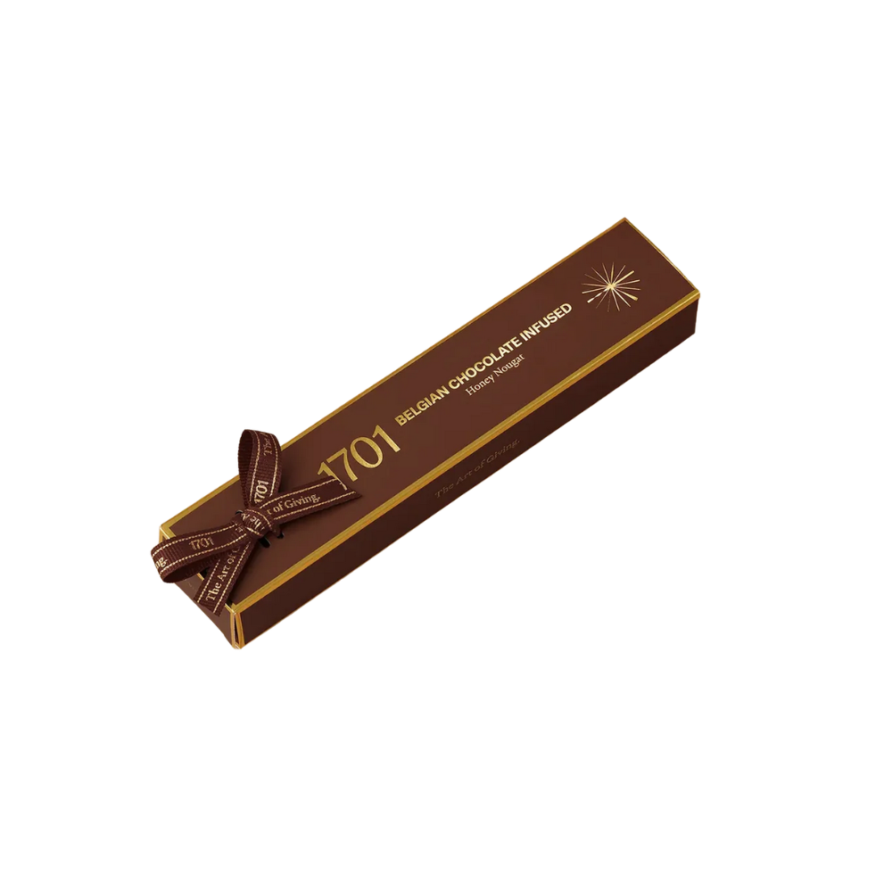 1701 Belgian Chocolate Infused Honey Nougat Bar 100g, hand‑wrapped with ribbon, showing smooth Belgian chocolate nougat texture in a premium South African artisanal presentation.