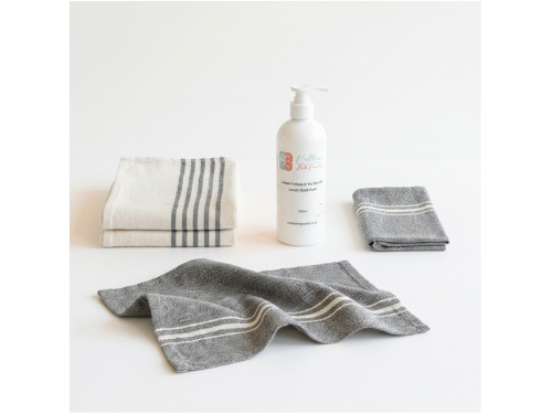 Barrydale Medium Country Towels with striped ends, napkins, and Mellow & Peachy Lemon Verbena & Tea Tree Hand Wash arranged as a coordinated gift set.